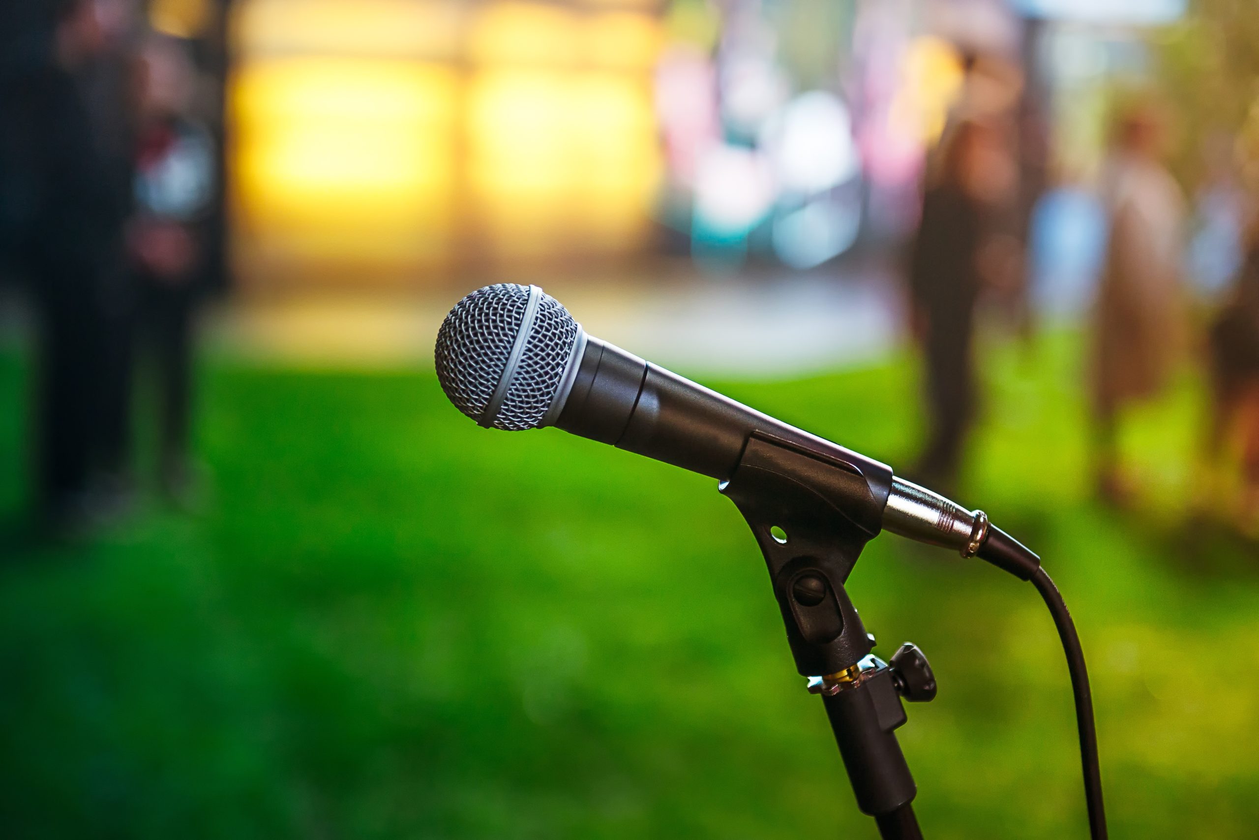 classic-microphone-on-abstract-blurred-bright-gree-2022-11-15-16-55-27-utc