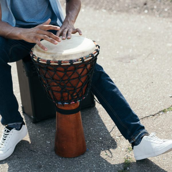 Cropped view of African american man with djembe performing on street